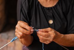 Older woman's artistic needlework.