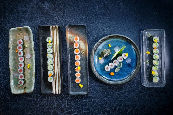 Set of various types of sushi on blue marble table