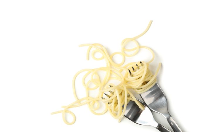 Forks with tasty pasta isolated on plain background