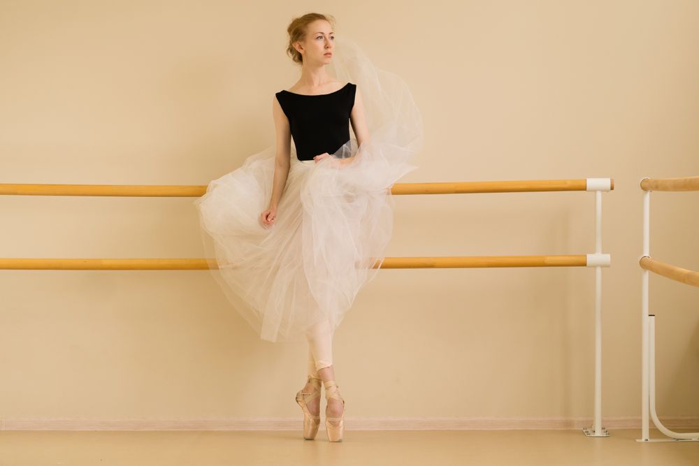 Ballet dancer poses elegantly in dance studio