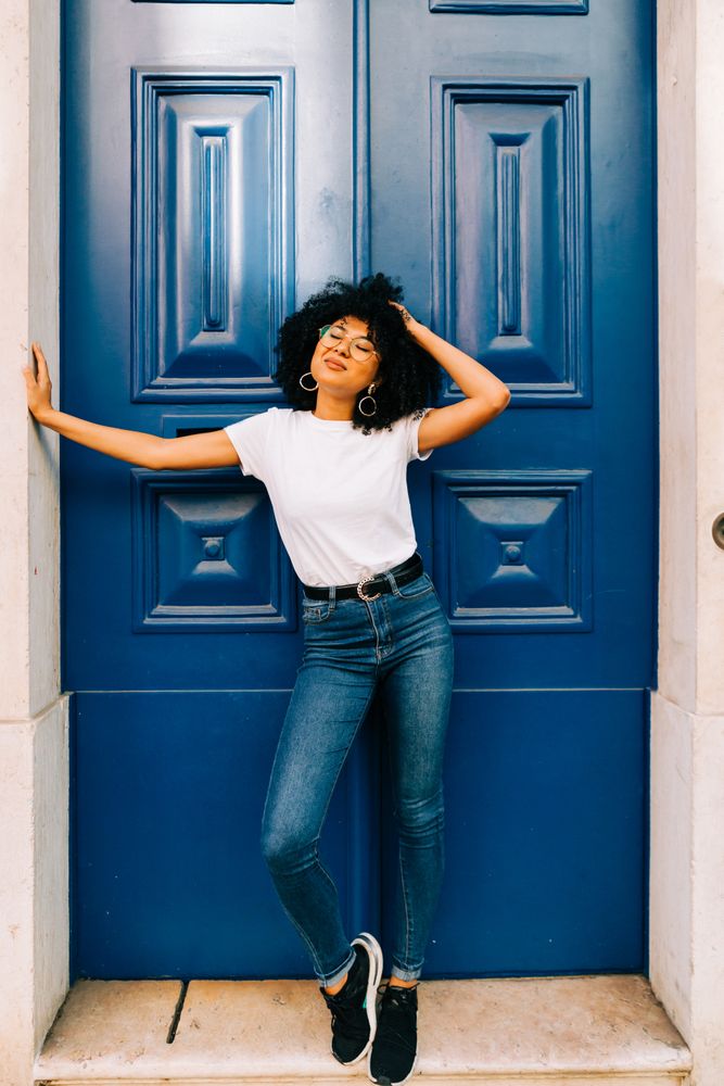 Stylish Black female by blue door