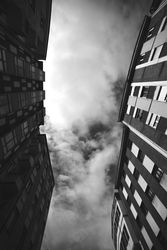 Facades of high buildings and cloudy sky