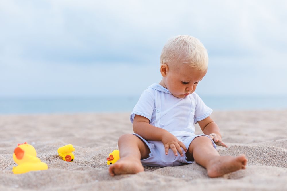 Baby boy playing with rubber ducks