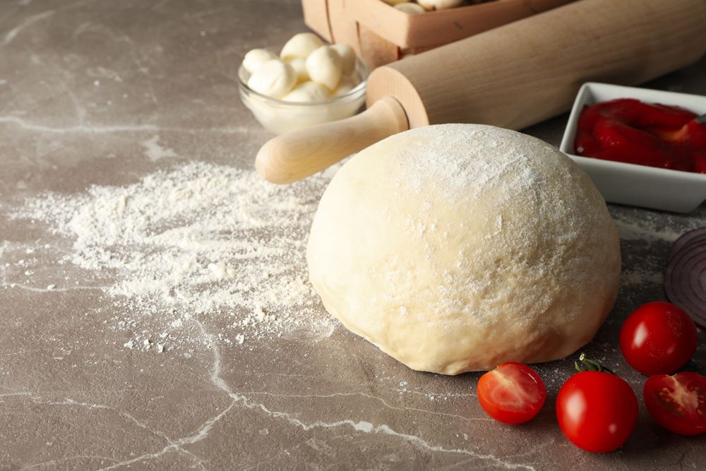 Ingredients for cooking pizza on gray background