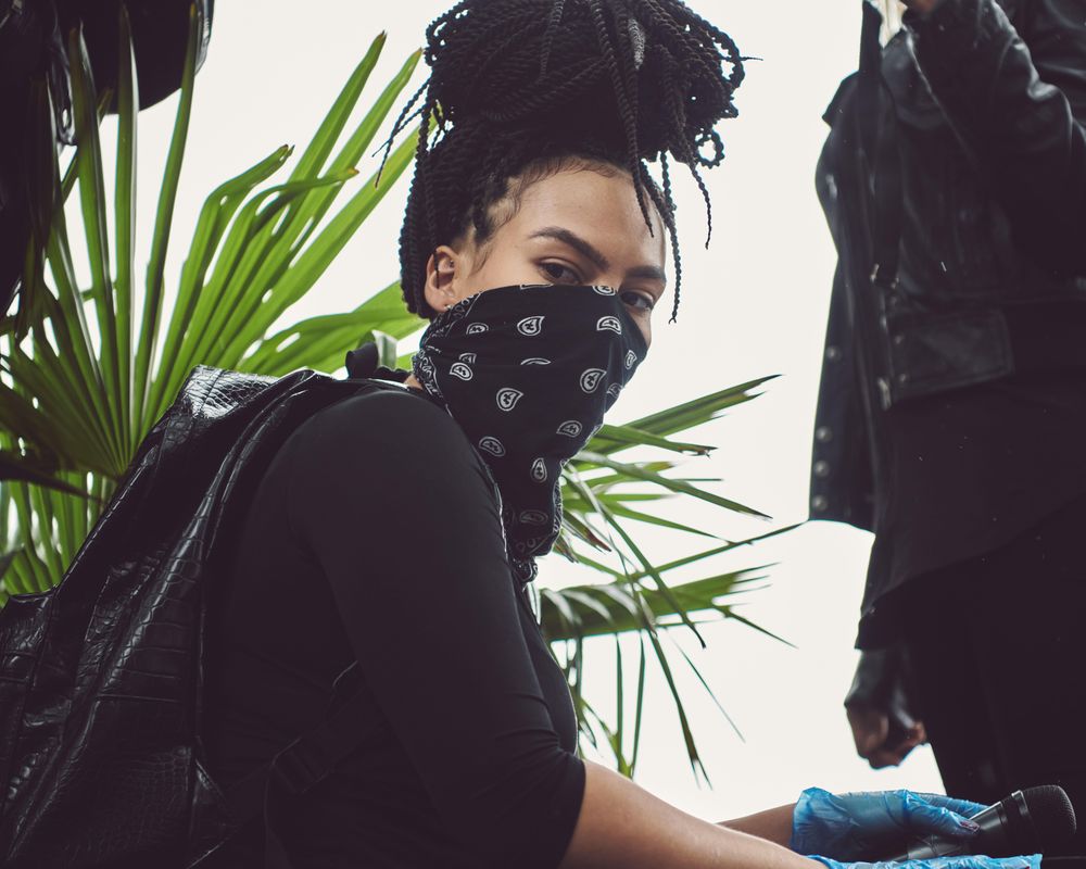 London, England, United Kingdom - June 6th, 2020: Woman with braids and bandana at protest