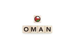 Wooden blocks bearing the name and flag of Oman.
