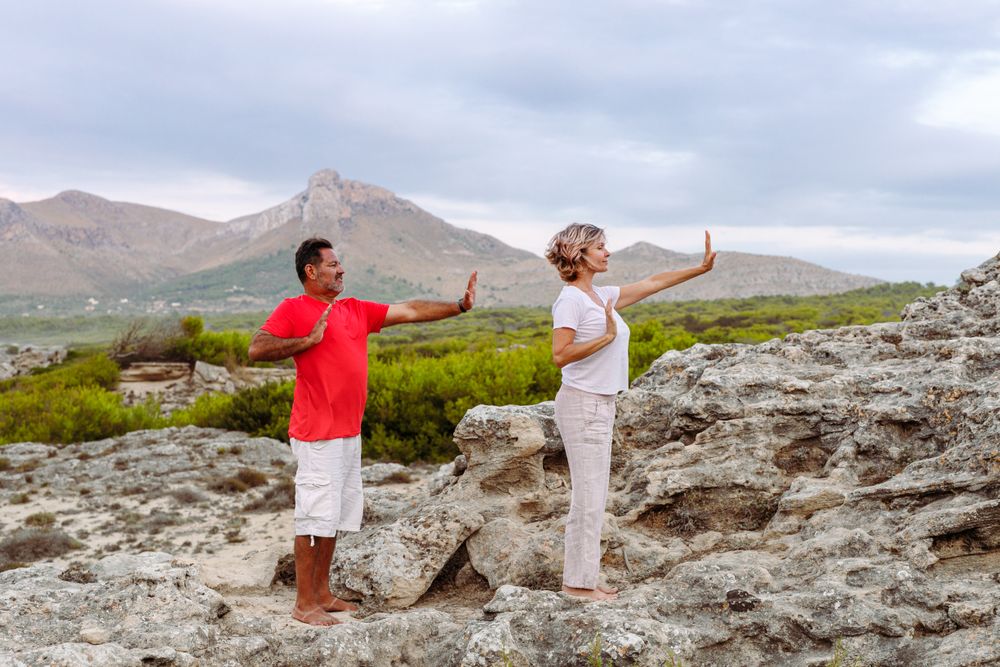 Couple meditating on rock