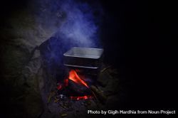 Water on square pan over campfire 4Nqpg5