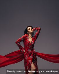 Sensual woman posing in red dress 4AzVAY