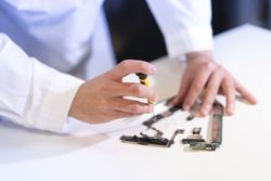 Young man repairing modern device