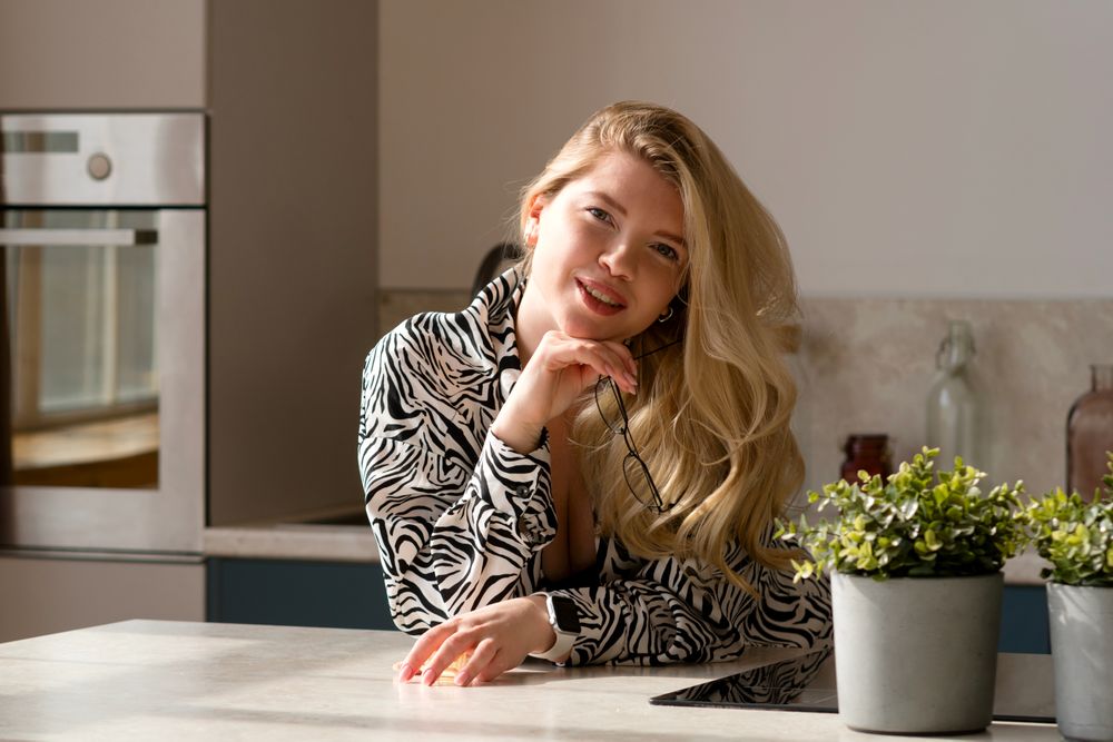 Smiling woman with glasses at table