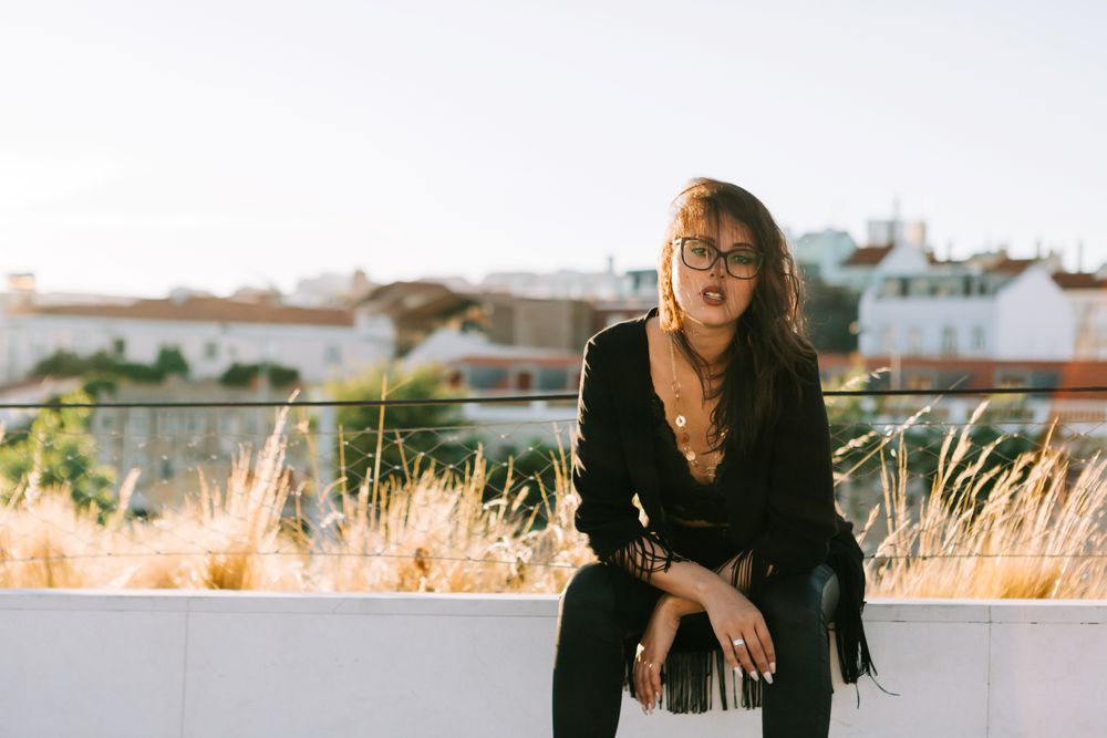 Trendy female standing on urban background