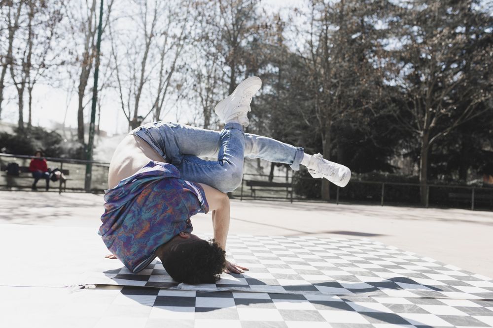 Man dancing break dance in park