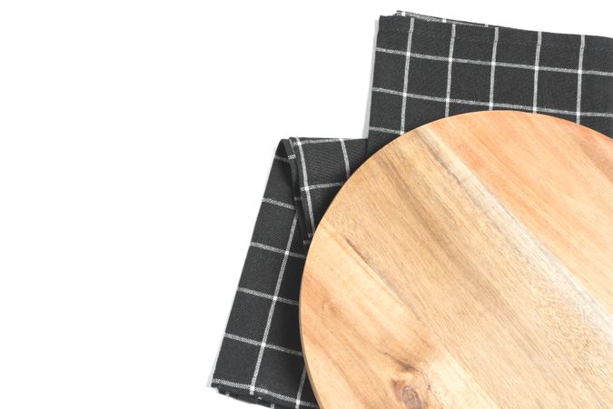 Cutting board with kitchen towel isolated on plain background, top view