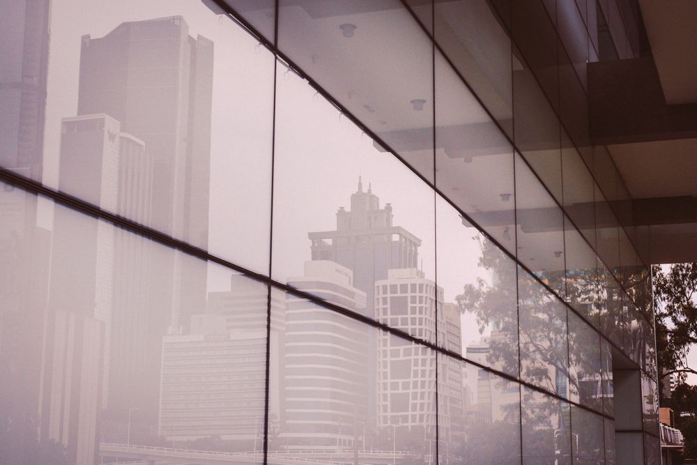 Reflection of cityscape of light tiles during daytime