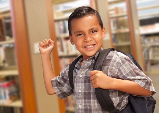 Hispanic Student Boy with Backpack in the Library