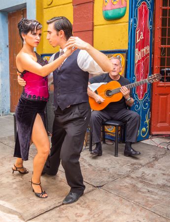 Buenos Aires, Argentina February, 01 2014: Couple dancing on street to guitar music
