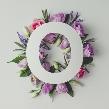 Colorful flowers, leaves and  paper “O”