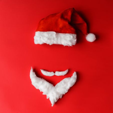 Santa hat and beard with mustache on red background