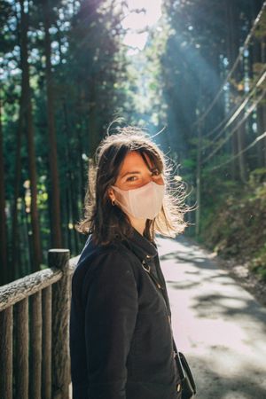 Female tourist with facemask in Takao Mountain near Tokyo, Japan