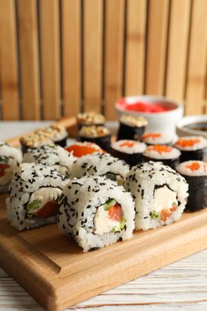 Delicious sushi rolls on wooden background, close up. Japanese food