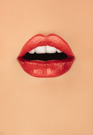 Beautiful lips of female over beige background