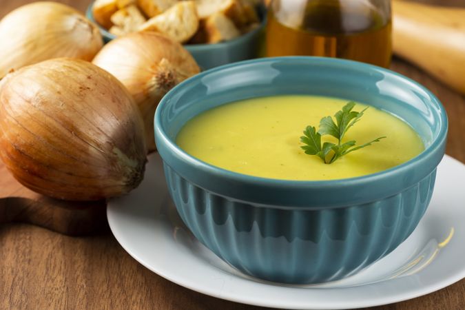 Bowl with onion soup and croutons on the table.