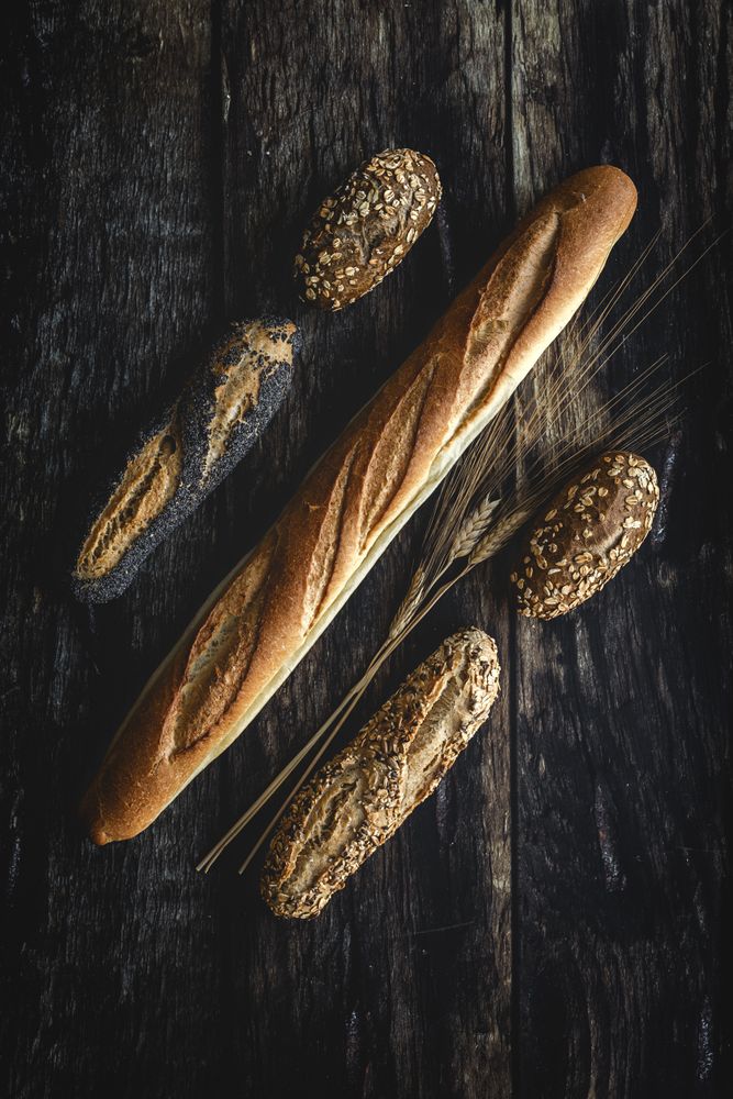 Assorted gold homemade bread on dark wood background