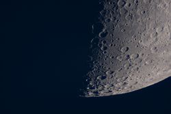 Close-up of lunar surface showing numerous prominent moon craters.