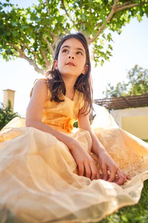 Girl sitting on grass and looking away