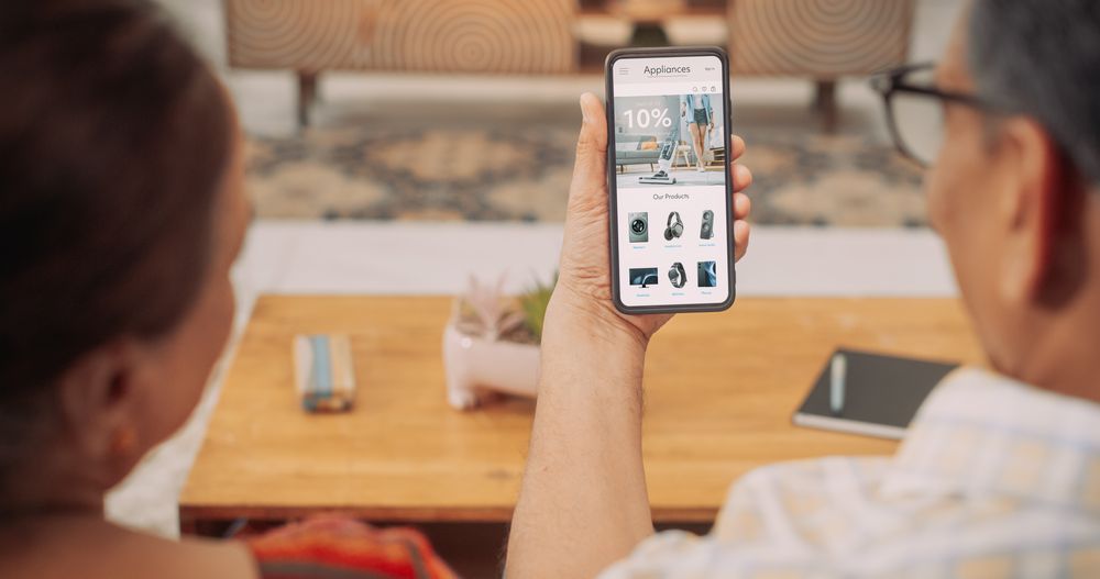 Mature Couple Using Smartphone to Buy Appliances From the Comfort of Their Home