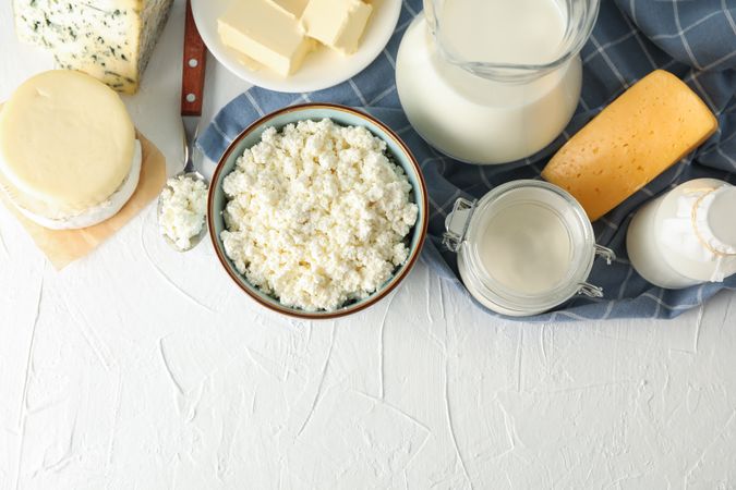 Flat lay. Different dairy products on light background, copy space