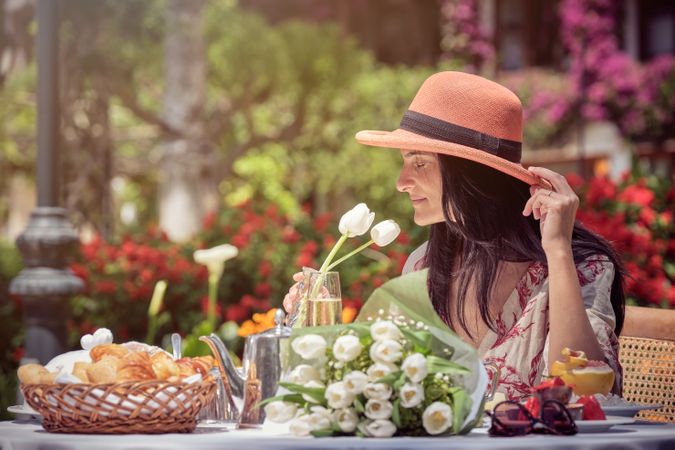 Woman Smelling White Flowers
