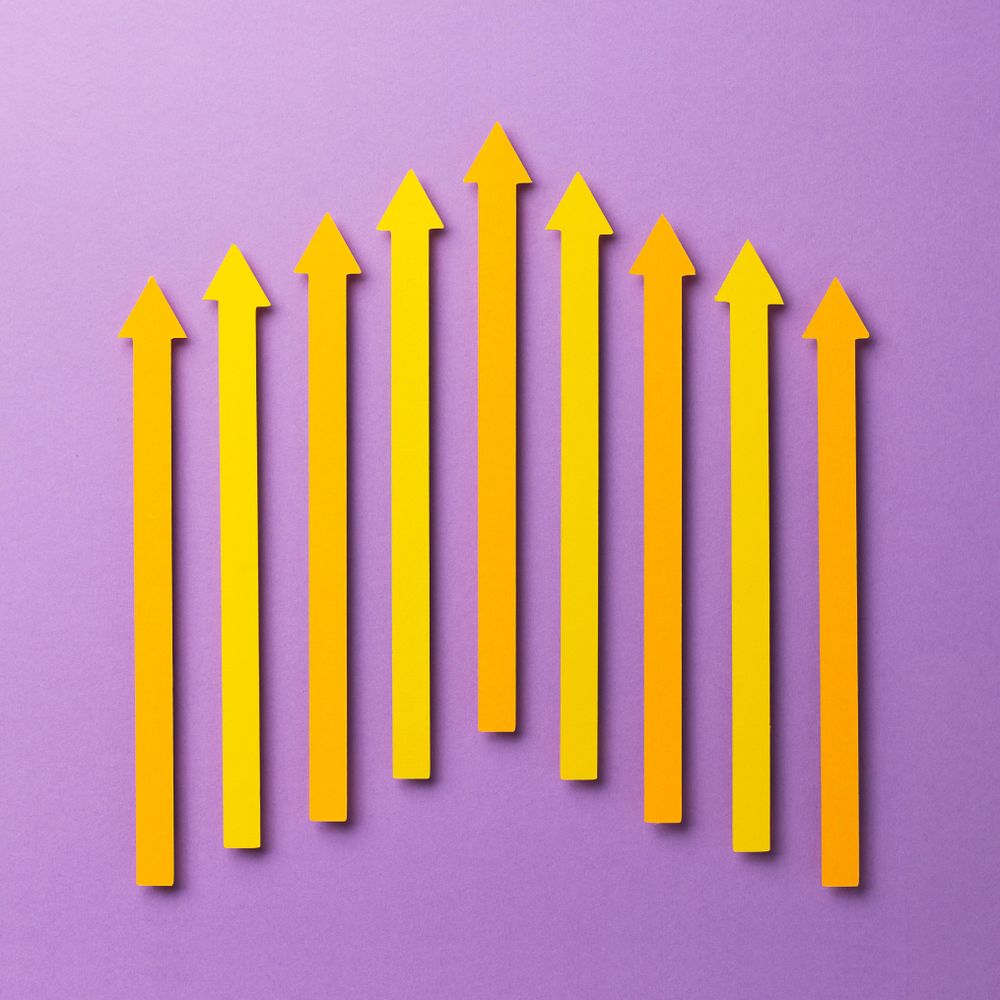 Yellow paper arrows on purple background