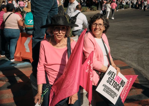 Mexico City, Mexico - February 26th, 2022: two mature woman dressed in pink at protest