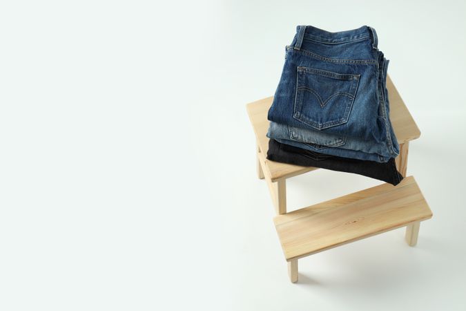 Folded jeans on a wooden chair