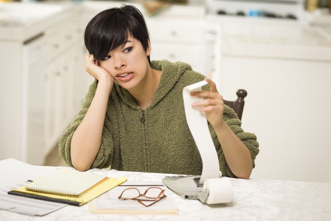 Young Woman Agonizing Over Financial Calculations