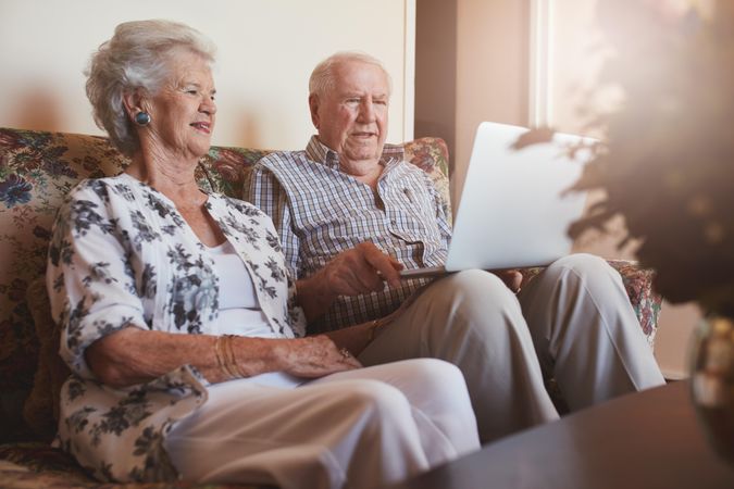 Content mature couple with laptop