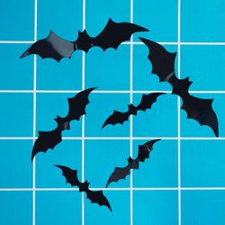 Bats flying around on a sky blue background