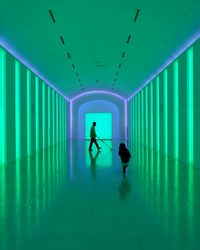 Two people in green spacious room