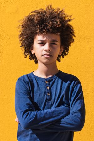 Pensive Black boy with Afro hairstyle