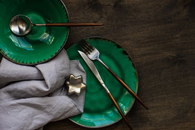 Rustic table setting with bright green ceramic plates and ornaments