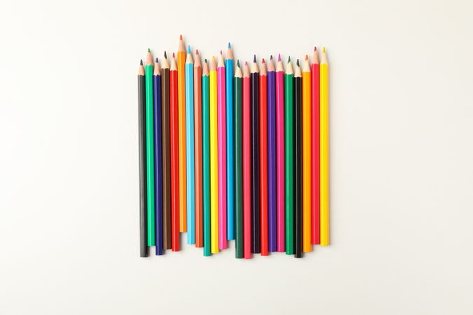 Colorful pencils on blank background, top view