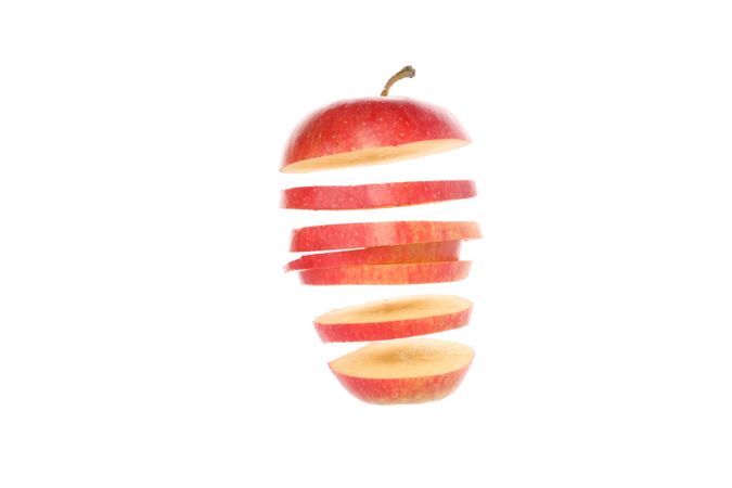 Sliced red apple isolated on light background