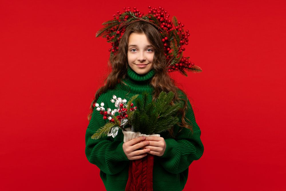 Young girl in green sweater holding festive bouquet