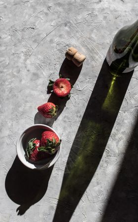 Strawberries near bottle of drink