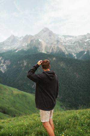 Anonymous male admiring view of mountain ridge