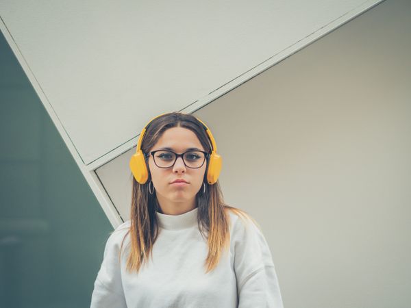 Trendy young woman with headphones and smartphone