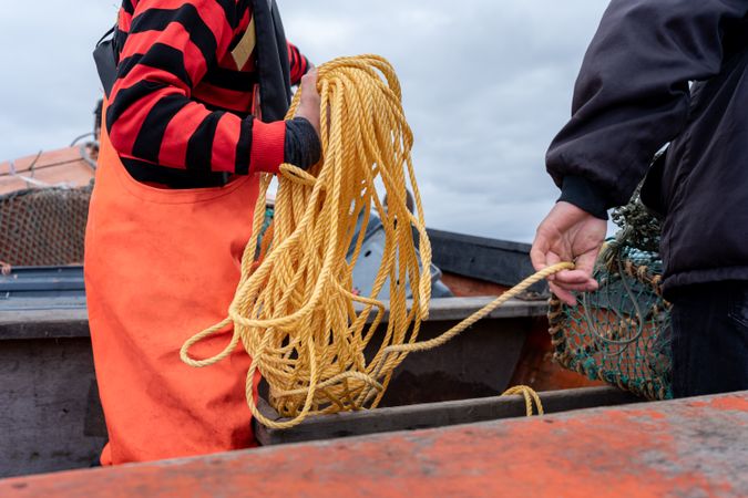 Fisherman holding a rope to retrieve the fishing net