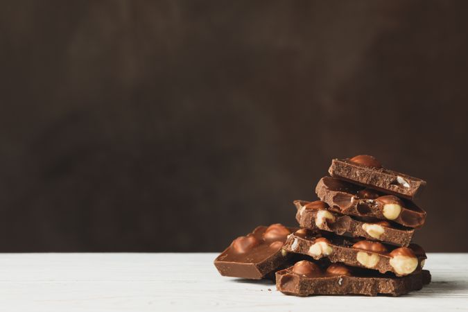 Tasty chocolate pieces on wooden table